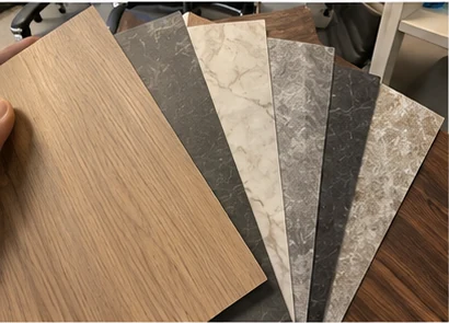 Architectural film samples fanned out: wood, stone and marble effects