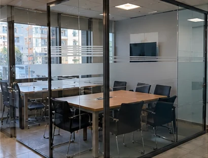 Glass-walled meeting room with frosted lines across the partition