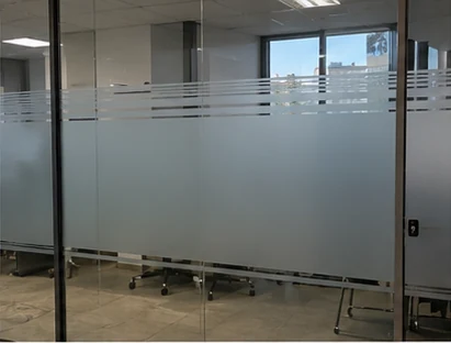 Glass office partition with a frosted band and fine clear lines at eye level